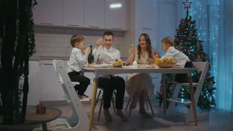 Festive-family-dinner.-A-family-with-two-children-at-the-table-on-Thanksgiving.-Celebrate-the-new-year-together.-Dinner-on-Christmas-Eve.-High-quality-4k-footage